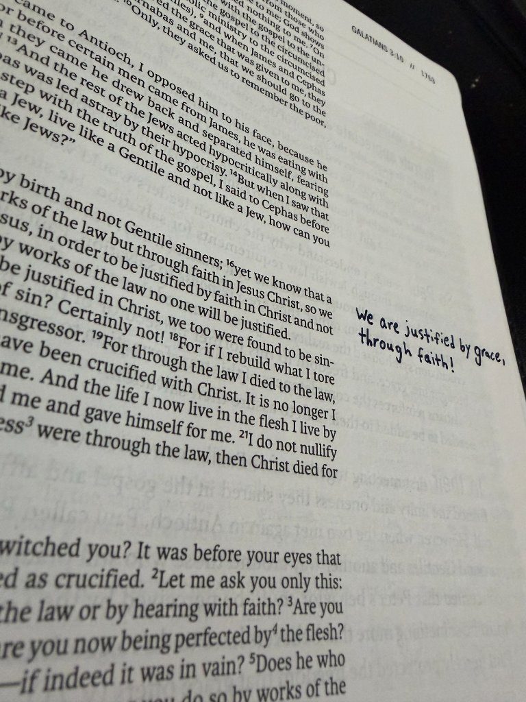 A handwritten note beside Galatians 2:16 in the margin of a printed Bible: We are justified by grace, through faith!